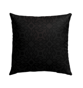 Meadow Magic Outdoor Pillow placed on an outdoor chair, enhancing a garden's aesthetic appeal.